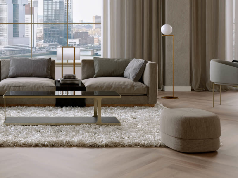 Woonkamer met een grijze bank en een hoogpolig kleed op een lichte eiken visgraatvloer van Room5 in de kleur Ambassador Oak