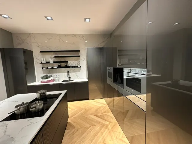 Showroomkeuken met een donker eiland en een wit marmerlook blad